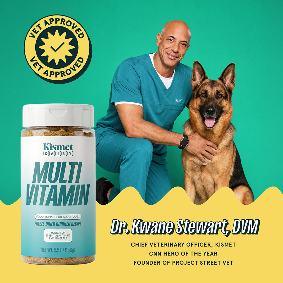 Dr. Kwane Stewart, DVM, Kismet's chief veterinary officer, kneeling with a German Shepherd beside the Multivitamin canister